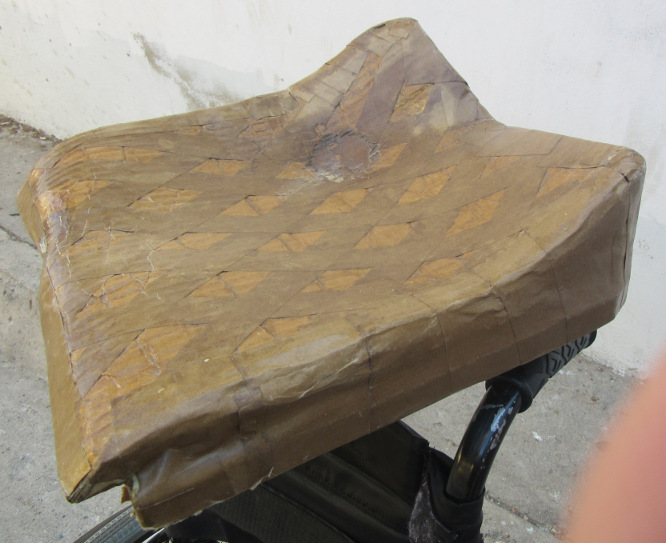 The completed cardboard cushion molded to fit Mónica’s irregular backside.