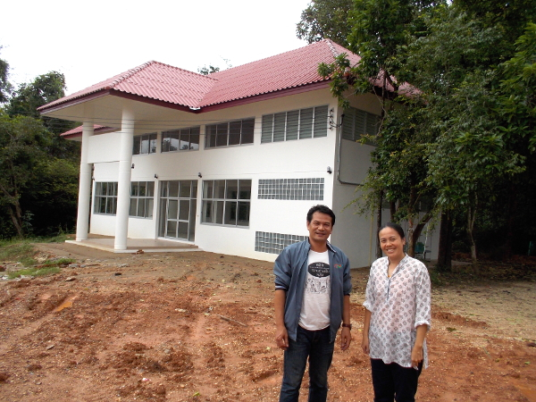  Cherry and Thom, dedicated leaders of Health and Share, stand in front of the program’s new center at Khemarat Hospital. The building was constructed as a gathering place for health promoter training, LGBT meetings, get-togethers of persons with HIV-AIDS, Buddy Home Care learning activities, and community workshops.